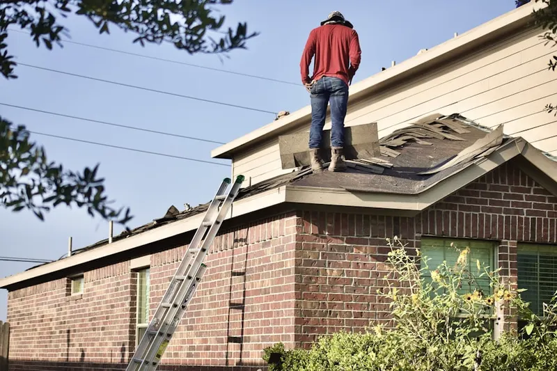 Professional roofer working on a residential roof in Walnut Hills